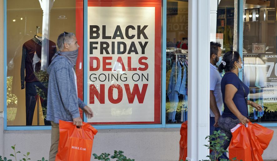Shoppers consider Black Friday deals at the Ellenton Premium Outlet stores in Ellenton, Fla. (AP Photo/Chris O&#39;Meara, file)
