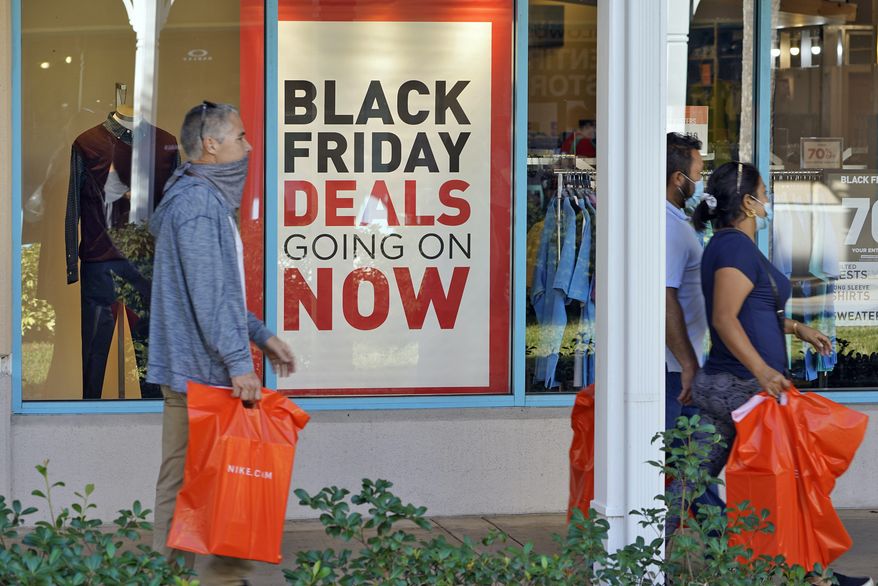 Shoppers consider Black Friday deals at the Ellenton Premium Outlet stores in Ellenton, Fla. (AP Photo/Chris O&#39;Meara, file)