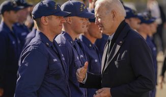 President Joe Biden greets members of the United States Coast Guard at the United States Coast Guard Station Brant Point in Nantucket, Mass., Thursday, Nov. 25, 2021. after virtually meeting with service members from around the world to thank them for their service and wish them a happy Thanksgiving. (AP Photo/Carolyn Kaster)