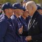 President Joe Biden greets members of the United States Coast Guard at the United States Coast Guard Station Brant Point in Nantucket, Mass., Thursday, Nov. 25, 2021. after virtually meeting with service members from around the world to thank them for their service and wish them a happy Thanksgiving. (AP Photo/Carolyn Kaster)