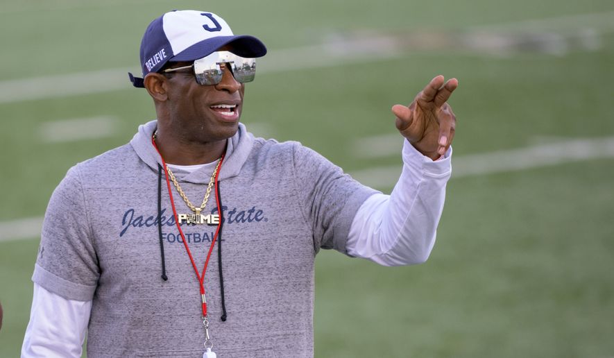 Jackson State head coach Deion Sanders points during an NCAA football game against Louisiana Monroe on Saturday, Sept. 18, 2021, in Monroe, La. Deion Sanders has been all over national TV, putting Jackson State in the spotlight every time his insurance commercials air. Hiring Eddie George has had a similar effect at Tennessee State.  (AP Photo/Matthew Hinton, File) **FILE**