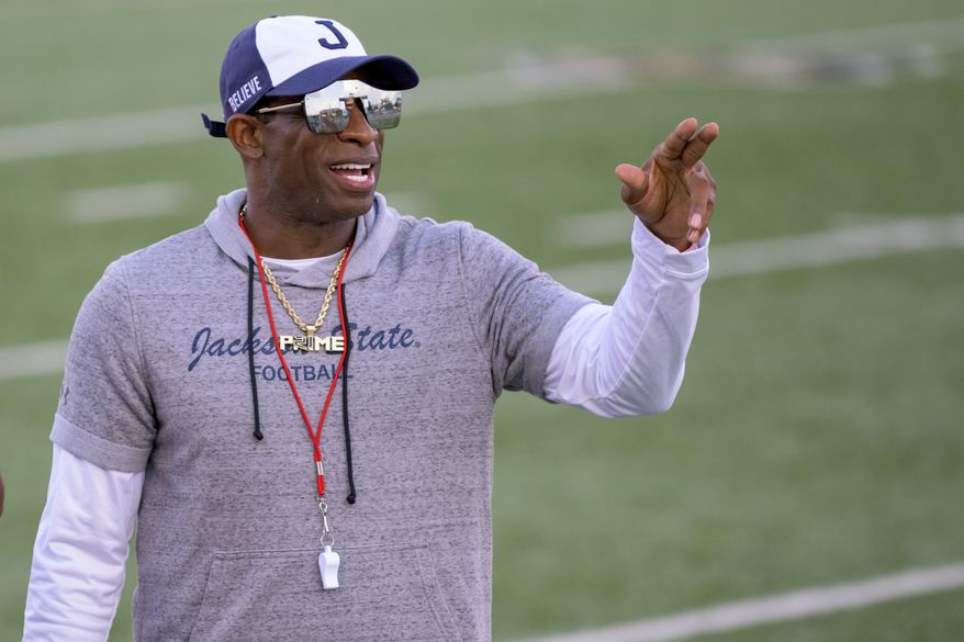 Jackson State head coach Deion Sanders points during an NCAA football game against Louisiana Monroe on Saturday, Sept. 18, 2021, in Monroe, La. Deion Sanders has been all over national TV, putting Jackson State in the spotlight every time his insurance commercials air. Hiring Eddie George has had a similar effect at Tennessee State.  (AP Photo/Matthew Hinton, File) **FILE**