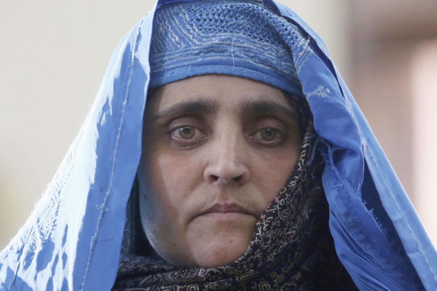 Afghan Girl with green eyes from famous National Geographic cover portrait is evacuated to Italy