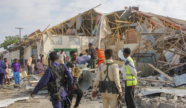 Security forces and rescue workers search for bodies at the scene of a blast in Mogadishu, Somalia, on Thursday, Nov. 25, 2021. Witnesses say a large explosion has occurred in a busy part of Somalia&#x27;s capital during the morning rush hour. (AP Photo/Farah Abdi Warsameh)