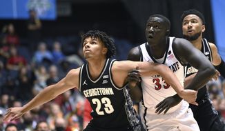 Georgetown forward Collin Holloway and San Diego State&#39;s forward Aguek Arop watch for a rebound during the second half of an NCAA college basketball game at the Wooden Legacy tournament in Anaheim, Calif., Thursday, Nov. 25, 2021. (AP Photo/Jayne Kamin-Oncea) **FILE**