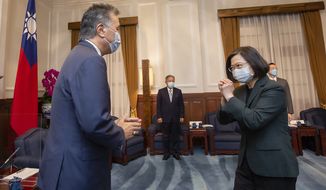 In this photo released by the Taiwan Presidential Office, U.S. Representative Mark Takano, D-Calif. left is greeted by Taiwanese President Tsai Ing-wen at the Presidential Office in Taipei, Taiwan on Friday, Nov. 26, 2021. Five U.S. lawmakers met with Taiwan President Tsai Ing-wen Friday morning in a surprise one-day visit intended to reaffirm the United States&#39; &quot;rock solid&quot; support for the self-governing island. (Taiwan Presidential Office via AP)