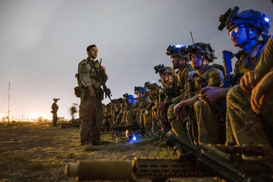 In this photo provided by the U.S. Air Force, soldiers, assigned to the 82nd Airborne Division, prepare to board a U.S. Air Force C-17 Globemaster III aircraft in support of the final noncombatant evacuation operation missions at Hamid Karzai International Airport in Kabul, Afghanistan, Aug. 30, 2021. The U.S. airlifted 124,000 people out of Kabul over about six weeks as the American-backed Afghan military and government fell to the Taliban. (Senior Airman Taylor Crul/U.S. Air Force via AP) **FILE**