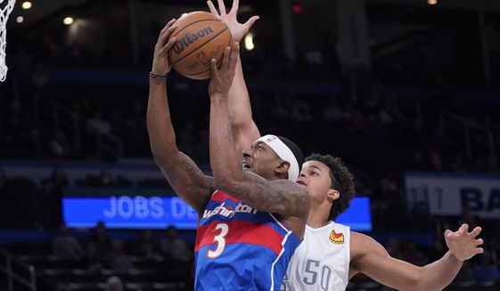 Washington Wizards guard Bradley Beal (3) goes to the basket in front of Oklahoma City Thunder forward Jeremiah Robinson-Earl (50) in the first half of an NBA basketball game Friday, Nov. 26, 2021, in Oklahoma City. (AP Photo/Sue Ogrocki)