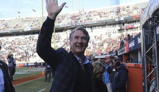 Virginia Gov.-elect, Glenn Youngkin waves to the crowd prior to the start of an NCAA college football game Saturday Nov 27, 2021, in Charlottesville, Va. (AP Photo/Steve Helber)