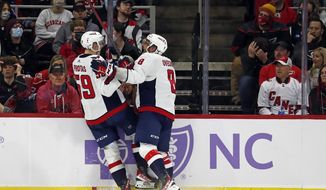 Washington Capitals&#x27; Aliaksei Protas (59) celebrates his goal with teammate Alex Ovechkin (8) during the second period of an NHL hockey game against the Carolina Hurricanes in Raleigh, N.C., Sunday, Nov. 28, 2021. (AP Photo/Karl B DeBlaker)