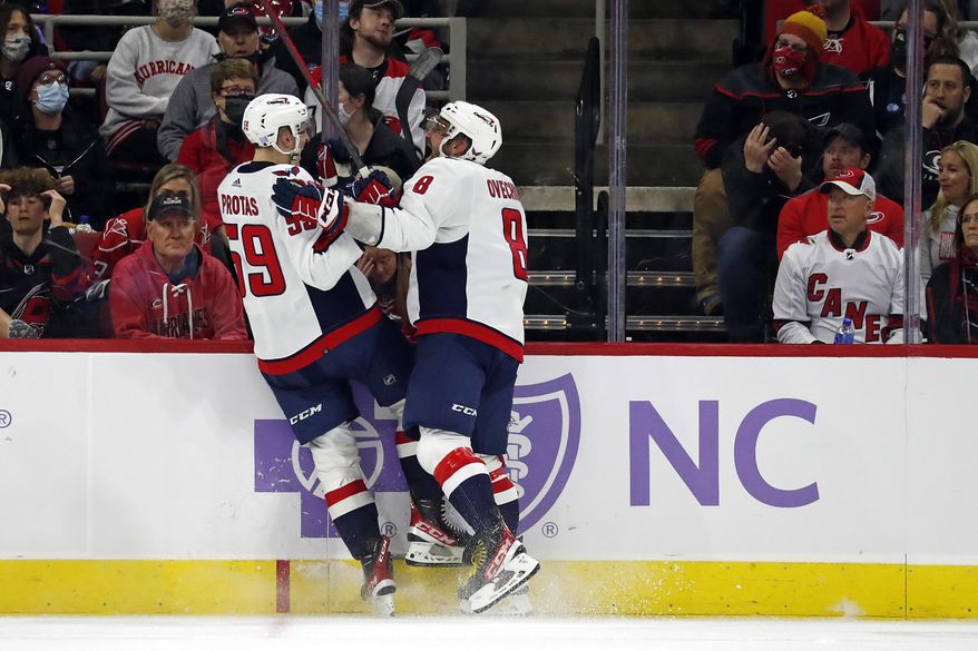 Washington Capitals&#39; Aliaksei Protas (59) celebrates his goal with teammate Alex Ovechkin (8) during the second period of an NHL hockey game against the Carolina Hurricanes in Raleigh, N.C., Sunday, Nov. 28, 2021. (AP Photo/Karl B DeBlaker)