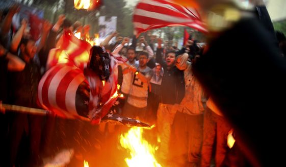 Iranian demonstrators burn representations of the U.S. flag during a protest in front of the former U.S. Embassy in response to President Donald Trump&#39;s decision Tuesday to pull out of the nuclear deal and renew sanctions, in Tehran, Iran, Wednesday, May 9, 2018. Iran and world powers resume talks in Vienna this week of Nov. 28, 2021,  aimed at restoring the nuclear deal that crumbled after the U.S. pulled out three years ago. There are major doubts over whether the deal can be reinstated after years of mounting distrust. (AP Photo/Vahid Salemi) **FILE**