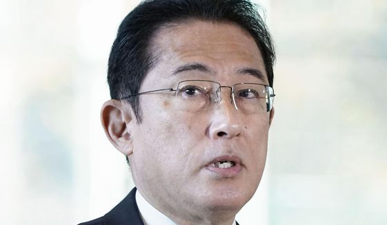 Japanese Prime Minister Fumio Kishida speaks to reporters at his official residence in Tokyo Monday, Nov. 29, 2021. Kishida said Monday that Japan is considering stepping up border controls as a new variant of the coronavirus found in South Africa spreads around the world. (Kyodo News via AP)