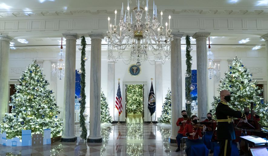 A Marine band plays Christmas music in the Grand Foyer of the White House during a press preview of the White House holiday decorations, Monday, Nov. 29, 2021, in Washington. (AP Photo/Evan Vucci)