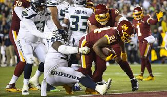 Washington Football Team running back Antonio Gibson (24) scores on a two-point conversion against the Seattle Seahawks during the second half of an NFL football game, Monday, Nov. 29, 2021, in Landover, Md. (AP Photo/Nick Wass)