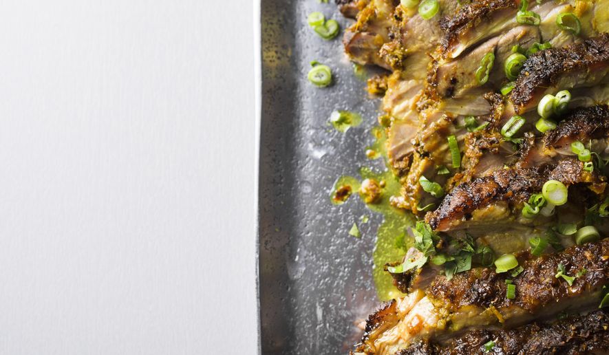 This image released by Milk Street shows a recipe for Asian roasted pork shoulder with turmeric and lemon grass. (Milk Street via AP)