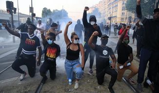 FILE- Protesters gesture during a demonstration against police violence and racial injustice,  Tuesday, June 2, 2020 in Paris. France is inducting Missouri-born cabaret dancer Josephine Baker, who was also a French World War II spy and civil rights activist – into its Pantheon. She is the first Black woman honored in the final resting place of France’s most revered luminaries. On the surface, it’s a powerful message against racism, bt by choosing a U.S.-born figure -- entertainer Josephine Baker – critics say France is continuing a long tradition of decrying racism abroad while obscuring it at home.  (AP Photo/Michel Euler, File)