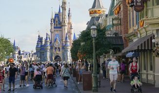 Guests stroll along Main Street at the Magic Kingdom theme park at Walt Disney World, Monday, Aug. 30, 2021, in Lake Buena Vista, Fla. (AP Photo/John Raoux, File)