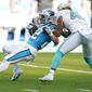 Miami Dolphins outside linebacker Duke Riley (45) grabs Carolina Panthers running back Christian McCaffrey (22) during the first half of an NFL football game, Sunday, Nov. 28, 2021, in Miami Gardens, Fla. (AP Photo/Wilfredo Lee) **FILE**