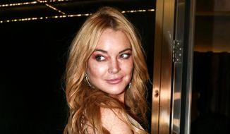 Actress Lindsay Lohan appears at the opening night of the Lohan Nightclub in Athens, Greece, Oct. 16, 2016. Lohan has told her followers on Instagram that she&#39;s engaged to boyfriend Bader Shammas. The 35-year-old &quot;Mean Girls&quot; star has been based in the skyscraper-studded city of Dubai for several years. (AP Photo/Yorgos Karahalis, File)