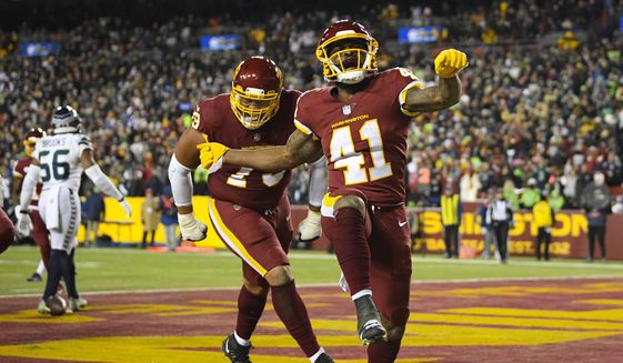 Washington Football Team running back J.D. McKissic (41) celebrating his touchdown against the Seattle Seahawks with teammate guard Ereck Flowers (79) during the second half of an NFL football game, Monday, Nov. 29, 2021, in Landover, Md. (AP Photo/Nick Wass) **FILE**