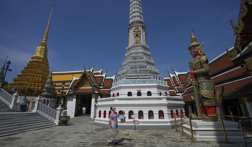 Tourists visit Grand Palace in Bangkok, Thailand, Monday, Nov. 29, 2021. Thailand is prized by China partly because this rapidly modernizing Southeast Asian nation enjoys access near Bangkok to the Gulf of Thailand, which opens onto the South China Sea. (AP Photo/Sakchai Lalit)