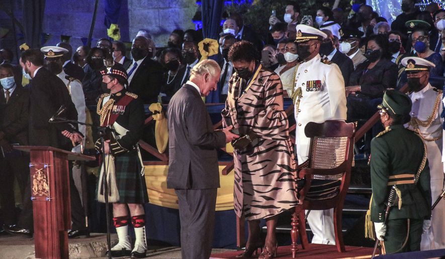 Barbados&#39; new President Sandra Mason, center right, awards Prince Charles with the Order of Freedom of Barbados during the presidential inauguration ceremony in Bridgetown, Barbados on Tuesday Nov. 30, 2021. Barbados stopped pledging allegiance to Queen Elizabeth II on Tuesday as it shed another vestige of its colonial past and became a republic for the first time in history. (AP Photo/David McD Crichlow)