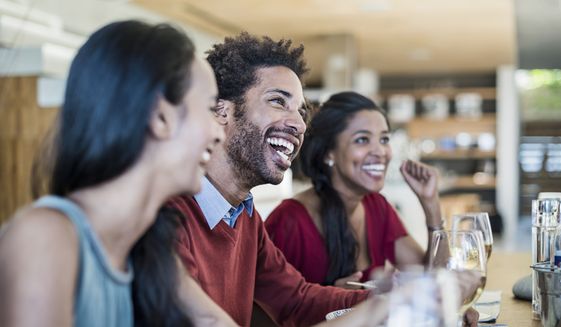 Friends having a laugh at dinner party. A misguided idea that others are too fragile to hear difficult things may be stopping Americans from telling coworkers what they need to learn and grow, according to a new study published Thursday.
