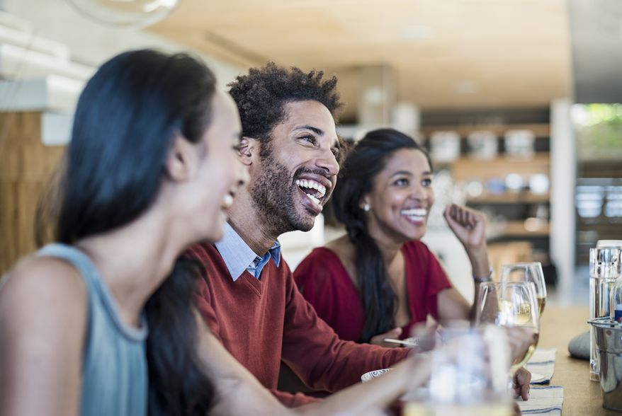 Friends having a laugh at dinner party. A misguided idea that others are too fragile to hear difficult things may be stopping Americans from telling coworkers what they need to learn and grow, according to a new study published Thursday.