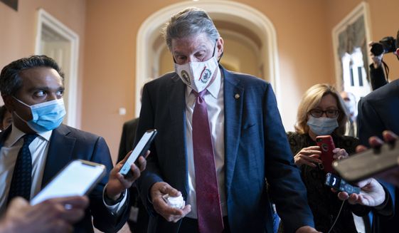 Sen. Joe Manchin, D-W.Va., leaves the office of Senate Minority Leader Mitch McConnell, R-Ky., after a lengthy meeting as the Senate grapples with raising the debt limit, funding the government, and negotiating President Joe Biden&#39;s domestic agenda, at the Capitol in Washington, Tuesday, Nov. 30, 2021. (AP Photo/J. Scott Applewhite)