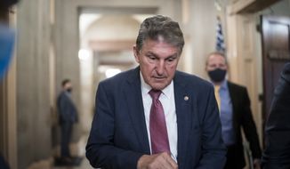 Sen. Joe Manchin, D-W.Va., leaves the office of Senate Minority Leader Mitch McConnell, R-Ky., after a lengthy meeting as the Senate grapples with raising the debt limit, funding the government, and negotiating President Joe Biden&#x27;s domestic agenda, at the Capitol in Washington, Tuesday, Nov. 30, 2021. (AP Photo/J. Scott Applewhite)