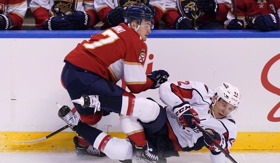 Florida Panthers center Frank Vatrano and Washington Capitals defenseman Martin Fehervary (42) battle for the puck during the second period of an NHL hockey game, Tuesday, Nov. 30, 2021, in Sunrise, Fla. (AP Photo/Wilfredo Lee) **FILE **