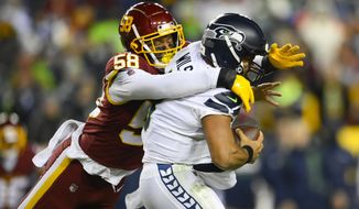 Seattle Seahawks quarterback Russell Wilson (3) is sacked by Washington Football Team defensive end Shaka Toney (58) during the second half of an NFL football game, Monday, Nov. 29, 2021, in Landover, Md. (AP Photo/Nick Wass)