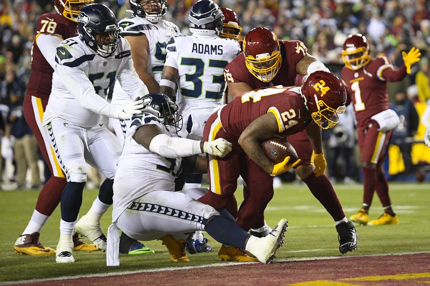 Washington Football Team running back Antonio Gibson (24) scores on a two-point conversion against the Seattle Seahawks during the second half of an NFL football game, Monday, Nov. 29, 2021, in Landover, Md. (AP Photo/Nick Wass)