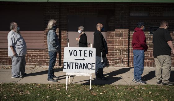 Voters wait in line outside a polling center on Election Day, in Kenosha, Wis. in this Nov. 3, 2020 file photo. Wisconsin Republicans are working to discredit the bipartisan system they created to run elections in the state after President Joe Biden narrowly won last year&#39;s presidential race, making the political battleground state the latest front in the national push by the GOP to exert more control over elections. (AP Photo/Wong Maye-E, File)