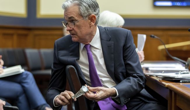 Federal Reserve Chairman Jerome Powell adjusts his watch as he prepares to speak to lawmakers during a House Committee on Financial Services hearing on Capitol Hill in Washington, Wednesday, Dec. 1, 2021.  (AP Photo/Amanda Andrade-Rhoades)