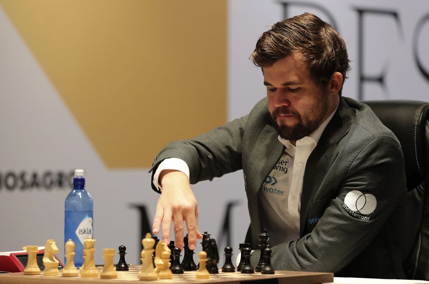 Norway's World Chess Champion Magnus Carlsen, makes a move in game five against Ian Nepomniachtchi of Russia, during the FIDE World Championship at the Dubai Expo, in Dubai, United Arab Emirates, Wednesday, Dec. 1, 2021. (AP Photo/Kamran Jebreili) ** FILE **