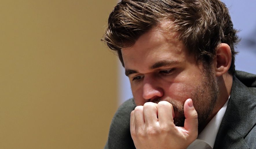 In this file photo, Norway&#39;s World Chess Champion Magnus Carlsen, takes a moment in game five against Ian Nepomniachtchi of Russia, during the FIDE World Championship at the Dubai Expo, in Dubai, United Arab Emirates, Wednesday, Dec. 1, 2021. (AP Photo/Kamran Jebreili)  **FILE**