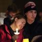 People attending a vigil embrace at LakePoint Community Church in Oxford, Mich., Tuesday, Nov. 30, 2021. Authorities say a 15-year-old sophomore opened fire at Oxford High School, killing several students and wounding multiple other people, including a teacher. (AP Photo/Paul Sancya)