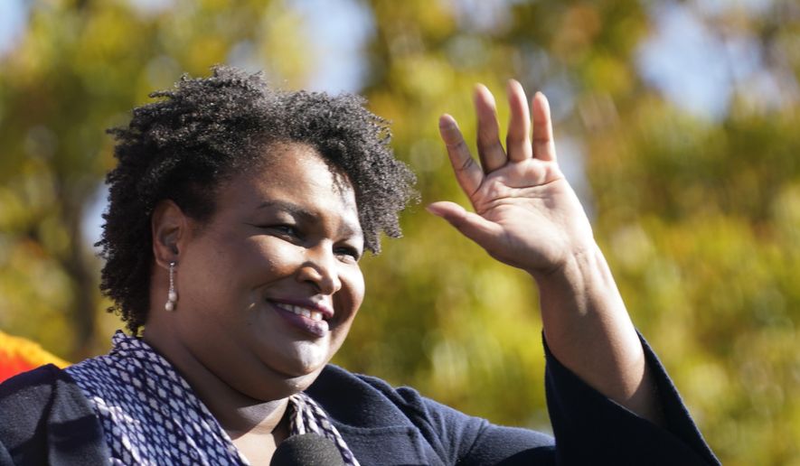 In this Monday, Nov. 2, 2020, photo, Stacey Abrams speaks to Biden supporters as they wait for former President Barack Obama to arrive and speak at a campaign rally for Biden at Turner Field in Atlanta. (AP Photo/Brynn Anderson) **FILE**
