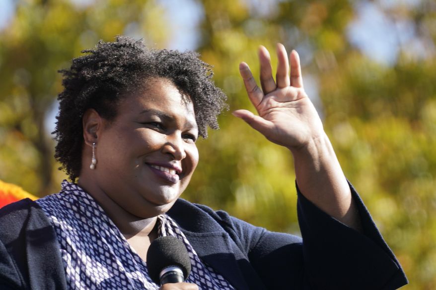 In this Monday, Nov. 2, 2020, photo, Stacey Abrams speaks to Biden supporters as they wait for former President Barack Obama to arrive and speak at a campaign rally for Biden at Turner Field in Atlanta. (AP Photo/Brynn Anderson) **FILE**