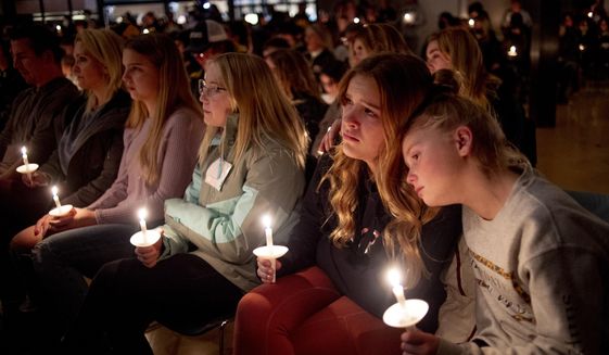 Emerson Miller, right, leans on her friend Joselyn&#39;s shoulder as they listen to Jessi Holt, pastor at LakePoint Community Church, during a prayer vigil at the church after the Oxford High School school shooting, Tuesday, Nov. 30, 2021, in Oxford, Mich. (Jake May/The Flint Journal via AP)