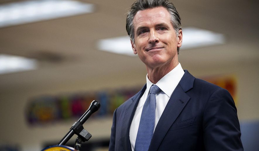 Governor Gavin Newsom announces the confirmation of California's first case of the omicron variant of COVID-19 during a visit to a vaccination clinic at Frank Sparkes Elementary School in Winton, Calif., on Wednesday, Dec. 1, 2021. (Andrew Kuhn/The Merced Sun-Star via AP)