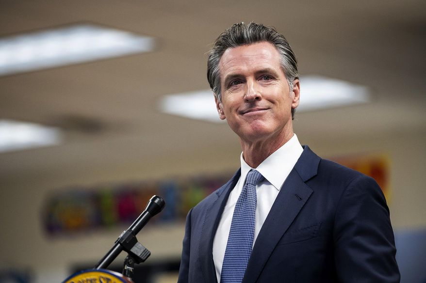 Governor Gavin Newsom announces the confirmation of California's first case of the omicron variant of COVID-19 during a visit to a vaccination clinic at Frank Sparkes Elementary School in Winton, Calif., on Wednesday, Dec. 1, 2021. (Andrew Kuhn/The Merced Sun-Star via AP)
