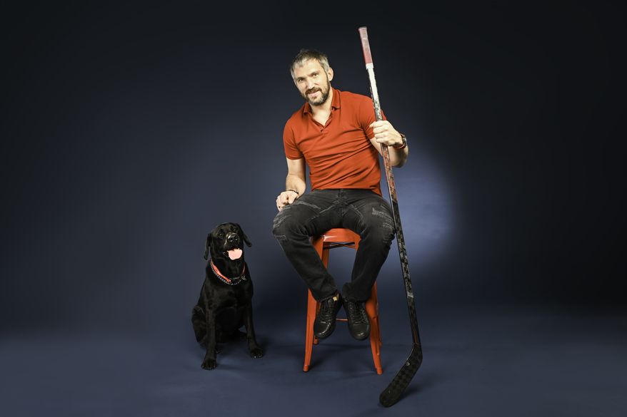 Washington Capitals winger Alex Ovechkin poses with his dog for the team&#39;s 2022 canine calendar. (Photo courtesy of Virgil Ocampo Photography)