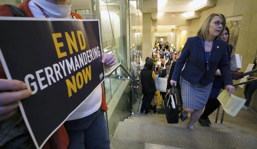 FILE - Del. Martha Mugler, D-Hampton, second from right, and Del. Danica Roem, D-Prince William, right, walk past a group of demonstrators as they head to the House of Delegates inside the Virginia state Capitol in Richmond, Va., on March 2, 2020. One of the two outstanding vote recounts requested by Mugler, of the 91st District, and Democratic Del. Alex Askew, who currently represents the 85th House District, that will settle whether Virginia Republicans have reclaimed the majority in the House of Delegates is set to get underway Thursday, Dec. 2, 2021, in Virginia Beach. (Bob Brown/Richmond Times-Dispatch via AP, File)