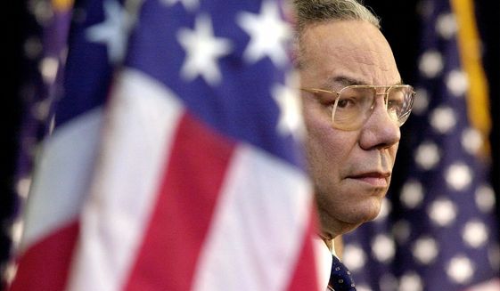Secretary of State Colin Powell looks on as President Bush addresses State Department employees at the State Department in Washington, on Feb. 15, 2001. Powell, who died Oct. 18, 2021, was a trailblazing soldier and diplomat. (AP Photo/Kenneth Lambert, File)