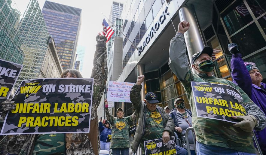 Members and supporters of the of the United Mine Workers of America demonstrate outside BlackRock headquarters, Thursday, Nov. 4, 2021, in New York. BlackRock is the largest shareholder of the Warrior Met Coal Inc. where union members have been on strike for nearly eight months seeking a contract that provides fair wages, affordable healthcare and reasonable rest and time-off for its workers. (AP Photo/Mary Altaffer)