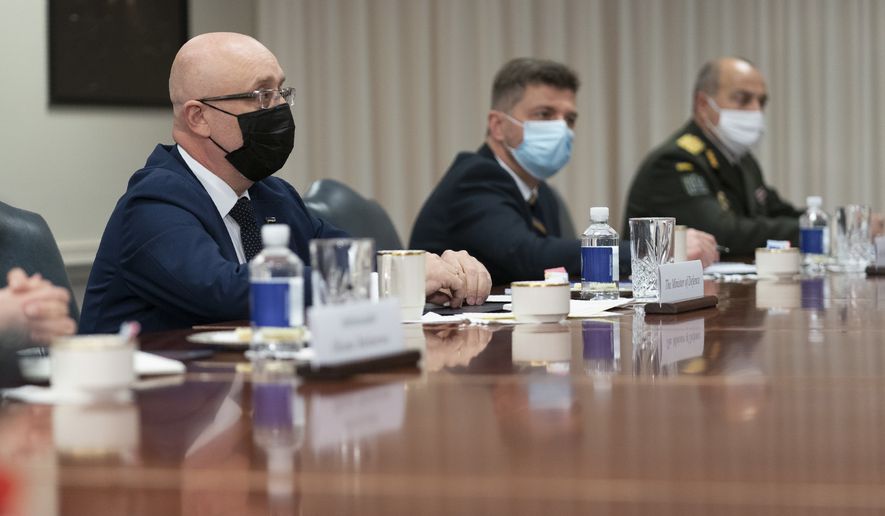 Ukrainian Defense Minister Oleksii Reznikov, left, speaks during a meeting with Defense Secretary Lloyd Austin, at the Pentagon on Nov. 18, 2021, in Washington. Ukraine’s defense minister estimates that Russia has amassed more than 94,000 troops near their borders and says there is a probability of a “large-scale escalation” in late January. Ukrainian and Western officials recently voiced alarm that a Russian troop buildup near Ukraine could herald an invasion. Moscow has denied planning to invade Ukraine and accused the West of fabricating claims to cover up its own aggressive designs. (AP Photo/Manuel Balce Ceneta, File)
