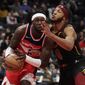 Washington Wizards&#x27; Montrezl Harrell, left, is fouled by Cleveland Cavaliers&#x27; Lamar Stevens (8) during the first half of an NBA basketball game, Friday, Dec. 3, 2021, in Washington. (AP Photo/Luis M. Alvarez)